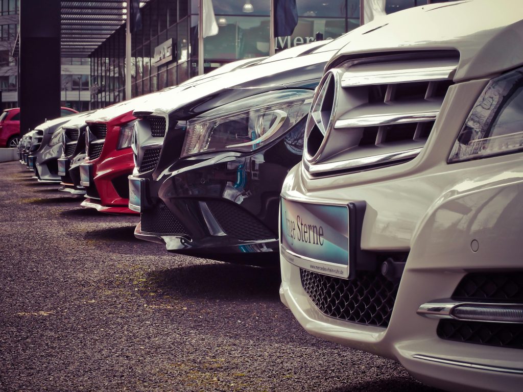 A row of cars lined up at a dealership