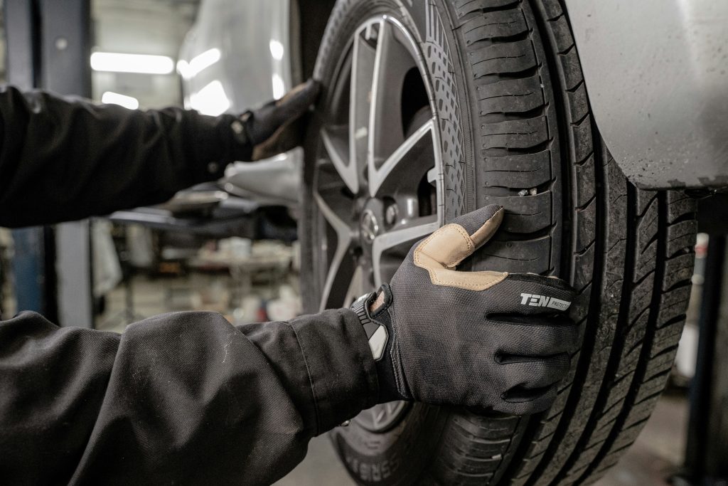 Mechanic inspecting a car wheel